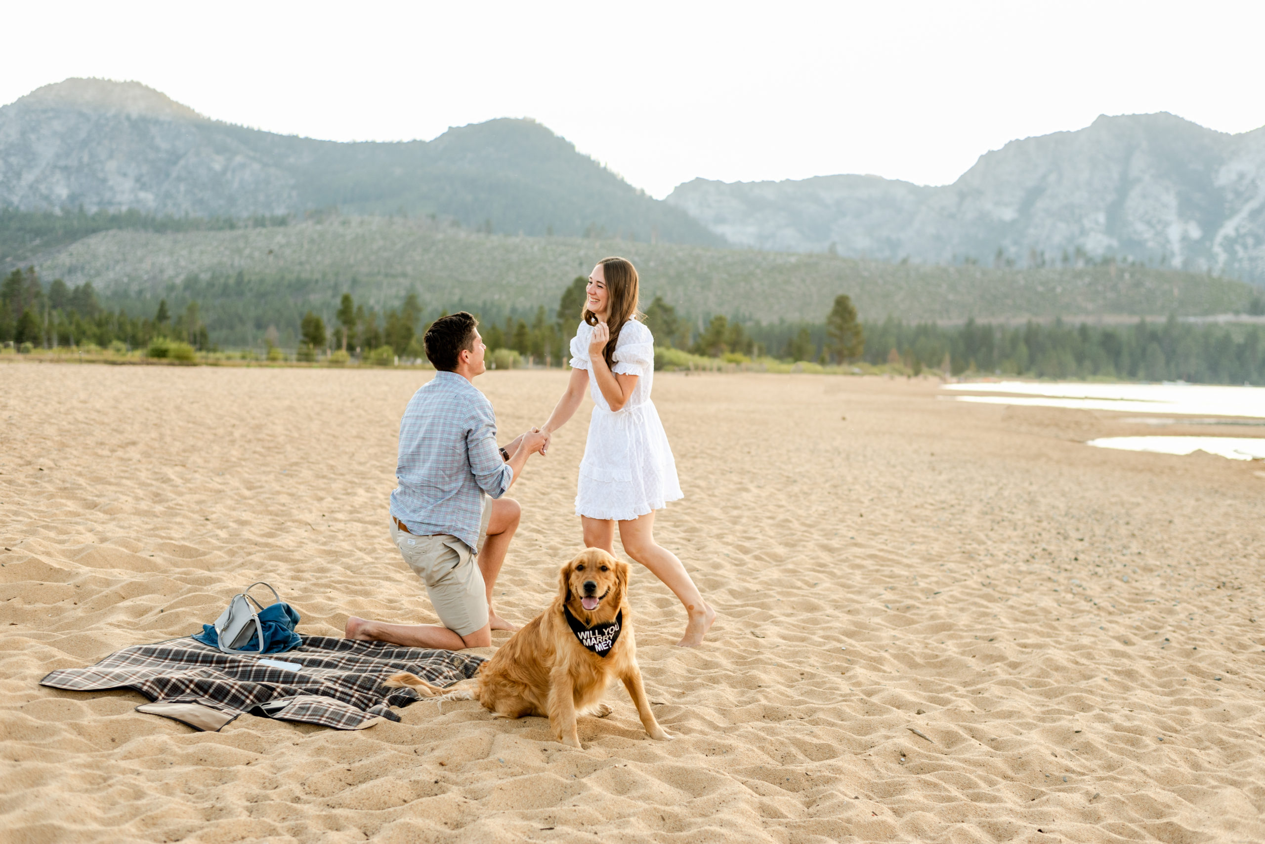 Guy proposing on beach in lake tahoe