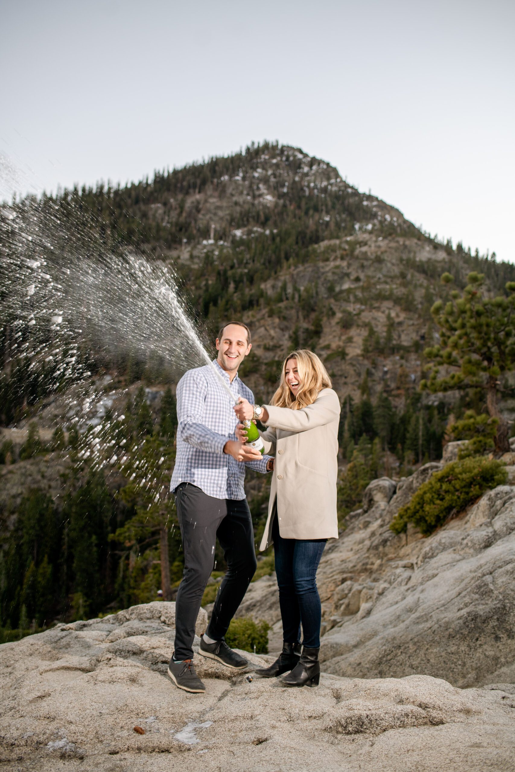 engaged couple in tahoe celebrating